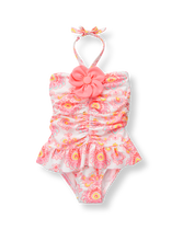 Glowing paisley print is just right for paradise. Ruched silhouette features ruffle skirt and 3D bloom. 80% Nylon/20% Spandex. UPF 50+. Fully Lined. Clasp Halter With Permanent Bow. Machine Washable; Imported. Flamingo Cove.
