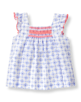 From picnics to the promenade in breezy cotton batiste with tile print. Features bright smocking and trim. 100% Cotton Batiste. Fully Lined. Button Back. Machine Washable; Imported. Getaway Breeze.
