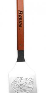 Florida Gators Sportula ~Florida sports enthusiasts will love this ultimate display of Florida Gators Merchandise. The Sportula is a heavy duty stainless steel grilling spatula that is perfectly designed for the Ultimate Tailgater! Go Gators!  Unique laser-cut design Heavy-duty stainless steel Hard maple handles with durable brass rivets Convenient bottle opener Custom heat-stamped lettering