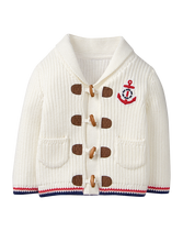 Anchor appliqué and toggle buttons add nautical detail to our knit cardigan. Finished with striped trim and shawl collar. 100% Combed Cotton. Button Front. Front Pockets. Machine Wash