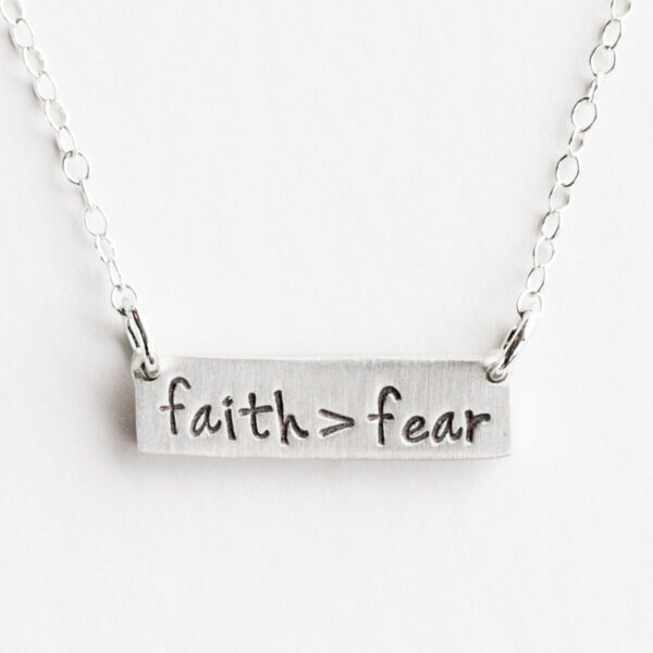 Faith > Fear - Pewter Bar Necklace This 'Faith > Fear' pewter bar necklace is a wonderful reminder to defeat the lie of fear with faith in God and the truth of His Word. This inspirational pewter necklace enhances all fashions and is a perfect gift for ladies for all occasions.Message:faith > fearMessage on backer card:let your faith be bigger than your fearProduct Details:Size:Bar pendant: 1 1/4"W x 5/16"HChain: 18"LMaterial:Bar pendant: fine pewterChain: rhodium platedHandcrafted in the USAProduct by The Vintage Pearl