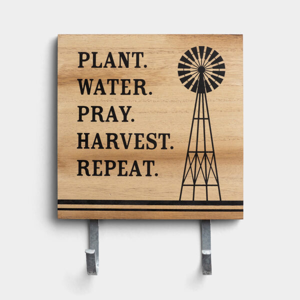 Plant. Water. Pray. - Wall Art with Hooks This eye-catching wall art is a perfect way to express your faith with your home decor and always be able to find your keys! The unique design will be sure to get a comment from everyone who enters your home.Message:Plant. Water. Pray. Harvest. Repeat.Product details:Inspirational wall artSize: 10 3/8" x 8" x 1/4"Material: wood composite